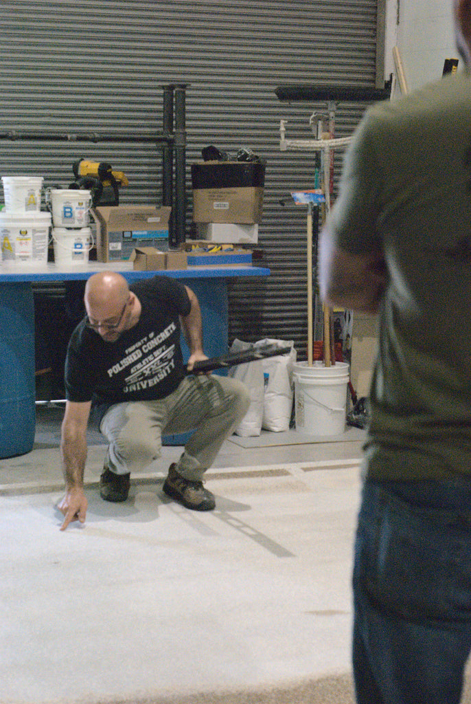 A contractor identifying the low spots in concrete for concrete leveling projects.
