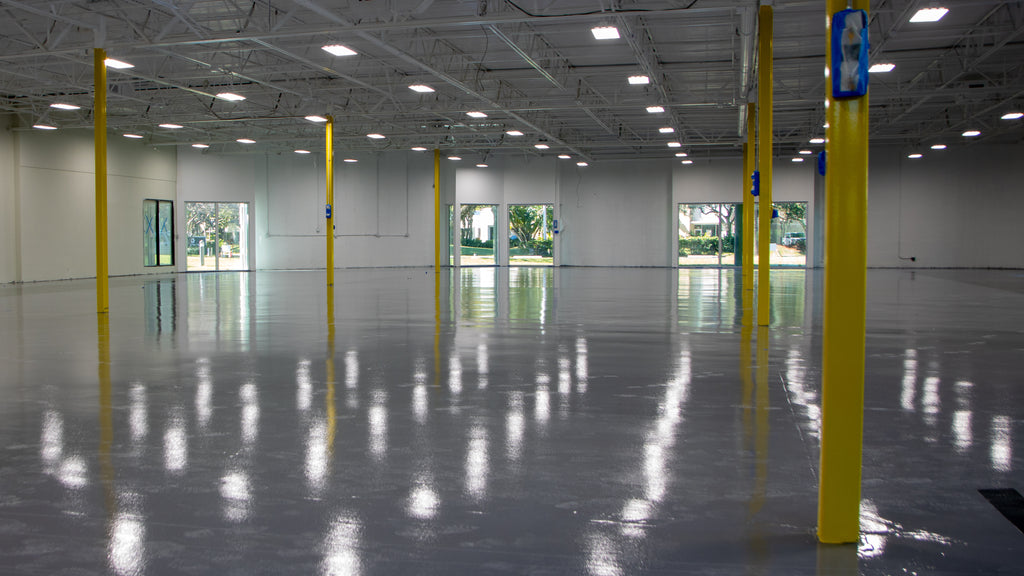 A large industrial warehouse floor with an epoxy flooring system & moisture seal installed.